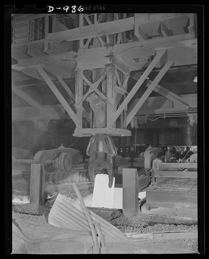 Steel alloy manufacture. Allegheny Ludlum Steel Corporation, Brackenridge, Pennsylvania. A heated ingot of steel is removed from the soaking pit. In this pit ingots are thoroughly heated to the extremely high temperature required for conversion into slabs, billets or sheet bars for further conversio