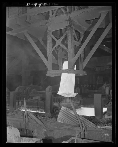 Steel alloy manufacture. Allegheny Ludlum Steel Corporation, Brackenridge, Pennsylvania. A heated ingot of steel is removed from the soaking pit. In this pit ingots are thoroughly heated to the extremely high temperature required for conversion into slabs, billets or sheet bars for further conversio
