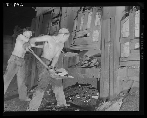 Steel alloy manufacture. Allegheny Ludlum Steel Corporation, Brackenridge, Pennsylvania. Open hearth steel is also made at this plant. Workers here shown are completing the charge to an open hearth furnace which has a capacity of about 100 tons per heat. Only small quantities of materials are charge