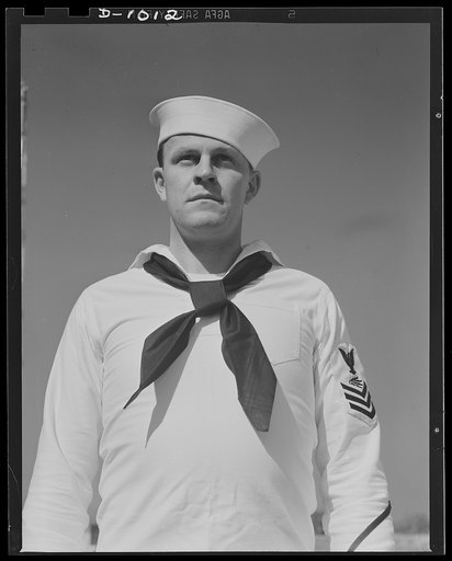 John Marshall Evans, Radioman, first class. Radioman Evans' uniform is the white service dress worn both aboard the ship and at shore station during the summer months or in the tropics. Naval Air Station, Anacostia, Washington, D.C. August 21, 1941