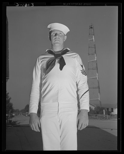 Naval Uniforms. John Marshall Evans, Radioman, first class. Radioman Evans' uniform is the white service dress worn both aboard the ship and at shore station during the summer months or in the tropics. Naval Air Station, Anacostia, Washington, D.C. August 21, 1941
