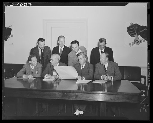 The first meeting of the Supply Priorities and Allocations Board, Washington, D.C., September 2, 1941. Seated left to right: Harry L. Hopkins, Special Assistant to the President, supervising lend-lease Program; William S. Knudsen, Director-General of the Office of Production Management (OPM); Henry 