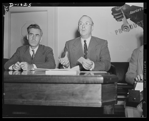 Henry A. Wallace, Chairman, Supply Priorities and Allocations Board and Vice-President of the United States, and Donald M. Nelson, Executive Director, Supply Priorities and Allocations Board and Director of the Priorities Division, Office of Production Management (OPM). Photograph taken at a joint p