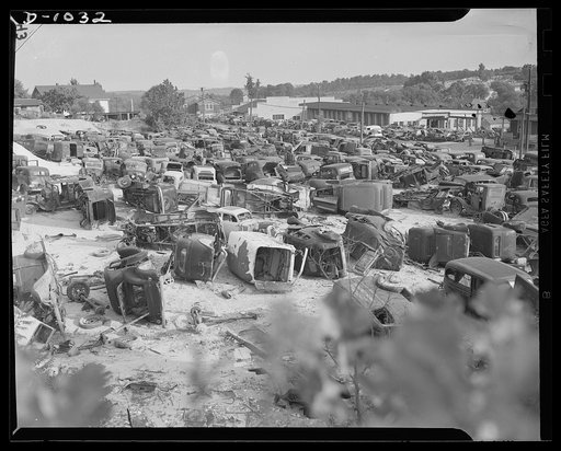 Conservation. Scrap iron and steel. An automobile graveyard outside Baltimore, Maryland. Scrapped oars are collected in such yards in every state. Usable parts are stripped from the chassis and the remainder of the car is sent to scrap iron dealers for processing and shipment to steel mills