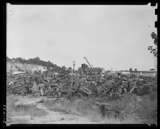 Conservation. Scrap iron and steel. An automobile graveyard outside Baltimore, Maryland. Scrapped oars are collected in such yards in every state. Usable parts are stripped from the chassis and the remainder of the car is sent to scrap iron dealers for processing and shipment to steel mills