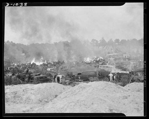 Conservation. Scrap iron and steel. Firing scrapped automobiles to provide steel for the National Defense production program. In these auto graveyards scrapped cars are stripped of all usable parts and then sent to scrap iron dealers who press and bale the metal for shipment to steel mills