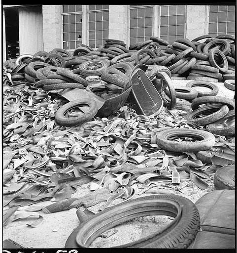 Conservation. Scrap iron and steel. Tire reclaimed from automobiles, scrapped for their iron and steel content. The rubber content of these tires can be reclaimed successfully to replace the use of new rubber in many articles. The U.S. Army is experimenting at the moment with the use of retreaded ti