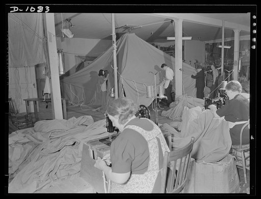 Army tent manufacture.  Schaeffer Tent and Awning Company, Denver, Colorado. 95 tents a day to house the expanding defense army. Rigging and inspecting of eight-man pyramidal tents which are being manufactured to rigid Army Quartermaster Corps specification
