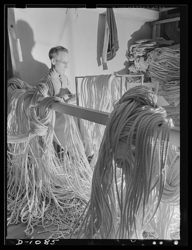 Army tent manufacture.  Schaeffer Tent and Awning Company, Denver, Colorado. Splicing eyes in guy line for eight-man pyramidal tents. This small plant produces ninety-five such tents a day to rigid Army Quartermaster Corps specifications