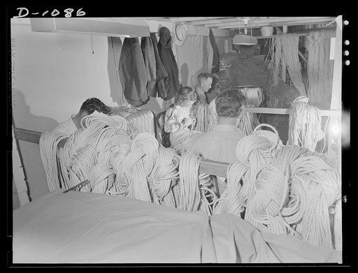 Army tent manufacture.  Schaeffer Tent and Awning Company, Denver, Colorado. Splicing eyes in guy line for eight-man pyramidal tents. This small plant produces ninety-five such tents a day to rigid Army Quartermaster Corps specifications