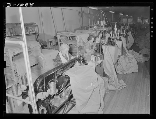 Army tent manufacture.  Schaeffer Tent and Awning Company, Denver, Colorado. Tying up an eight- man pyramidal tent for shipment to the expanding defense Army. This small plant manufactured ninety-five such tents a day under rigid Army Quartermaster Corps specifications