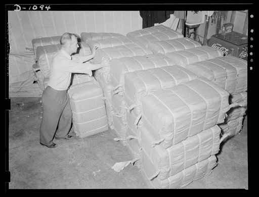 Langdon Tent and Awning Company, Wichita, Kansas. Bales of "pup" tents ready for shipment to the Army Quartermaster Corps supply depots. Each bale holds forty-eight tents which are made in two halves to lighten the pack load of the soldier in the field. Two soldiers join their half tents to form a t