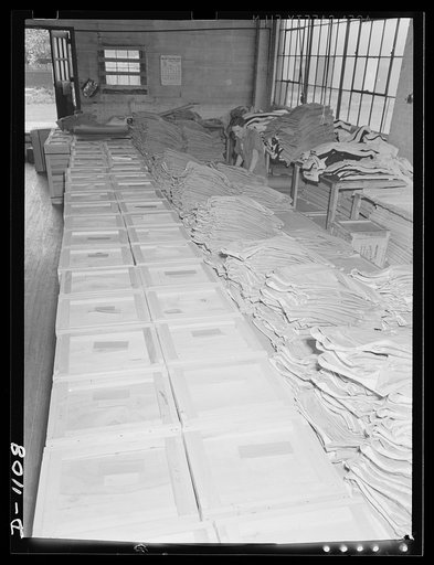 Army uniform trouser manufacture. Kane Manufacturing Company, Louisville, Kentucky. Thousands of trousers line up in packing cases for shipment to the expanding defense Army. Each case holds 75 trousers of a given size. This plant produces 1300 trousers a day in both khaki and wool serge