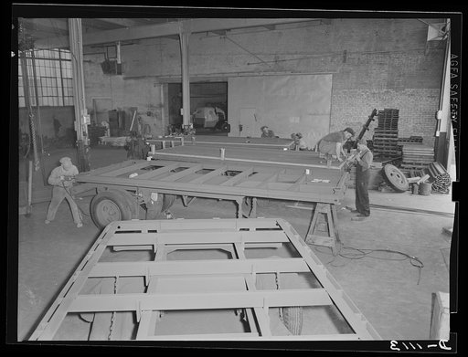 Trailers for defense transportation. Winter Weiss Company, Denver, Colorado. Flooring being laid on semi-trailers for general utility used around Army camps and supply depots. These trailers carry a payload of 7,000 pounds on a combination platform stake body of hardwood