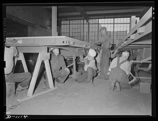 Trailers for defense transportation. Winter Weiss Company, Denver, Colorado. Flooring being laid on semi-trailers for general utility used around Army camps and supply depots. These trailers carry a payload of 7,000 pounds on a combination platform stake body of hardwood