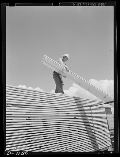 Building stockpiles. Ponderosa pine boards being stacked in a western sawmill. Efforts are being made (June 1941) to create a stockpile of lumber to insure a steady monthly output of ammunition cases. Lumber is also supplied from these mills for the construction of barracks and cantonments