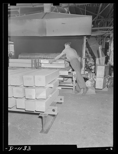 Aluminum. Reynolds Metal Company, Louisville, Kentucky. "Strong alloy" aluminum ingots, approximately six inches square, are loaded into the heating furnace where they are heated to 800 degree Fahrenheit before rolling operations