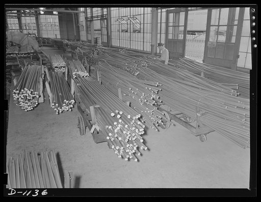 Aluminum. Reynolds Metal Company, Louisville, Kentucky. Truckloads of heat-treated "strong alloy" aluminum rod ready for straightening and finished operations. Worker is examining identification tags bearing data of chemical and physical analysis