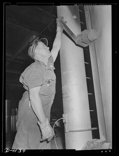 Aluminum. Reynolds Metal Company, Louisville, Kentucky. Sealing the doors of a huge annealing oven. These doors must be tightly sealed to control the atmosphere within the ovens and to prevent cooling spots