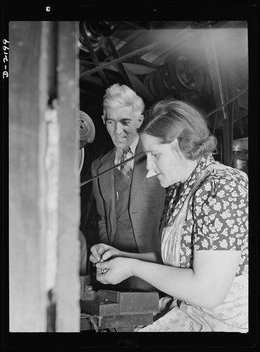 Dante Electric Company, Bantam, Connecticut. Completely at home on any of the score or so of different machines in the shop, Mrs. Dante appears to be the busiest person there. Mr. Dante watches her here as she works on a burring machine