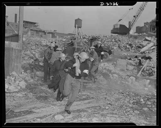 The air raid protective services. The speedy laying and coupling of firehose is often a difficult task, but it is essential if the auxiliary firemen are to function to the best advantage. They must learn to clamber like monkeys over debris, and must learn to estimate the strength of standing section