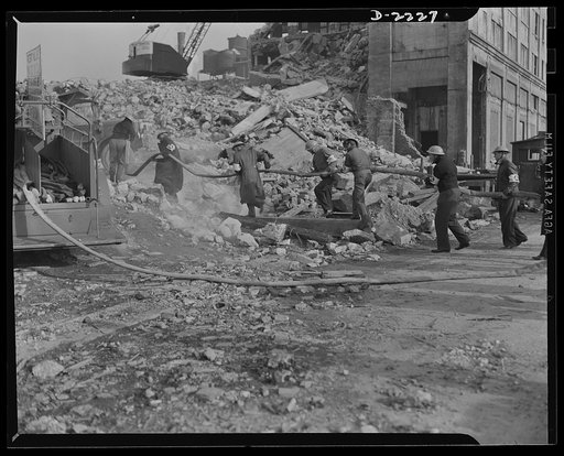 The air raid protective services. The speedy laying and coupling of firehose is often a difficult task, but it is essential if the auxiliary firemen are to function to the best advantage. They must learn to clamber like monkeys over debris, and must learn to estimate the strength of standing section