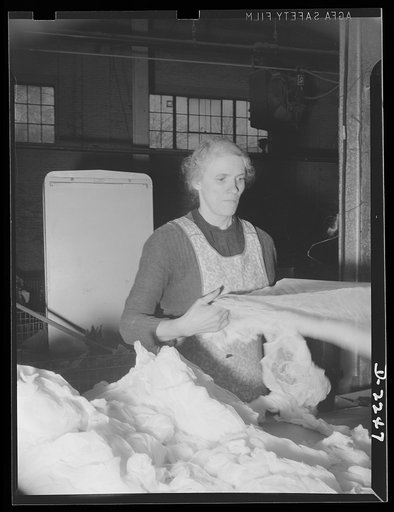 Rags Collection and processing. Women sorting rags in a large Eastern rag processing plant. After being sorted, the rags are compressed into tight bales for convenience in handling and storage. Old rags such as these are used in the manufacture of paper, roofing felt, fiber board, and similar materi
