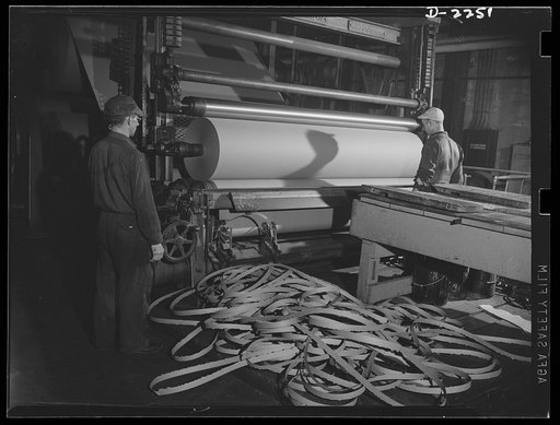 Rags. Collection and processing. Roofing being wound into rolls at a Maryland plant. Rags and waste paper are used extensively in the manufacture of this material. The strips on the floor are trimmings which are left after the edges of the roll have been made even