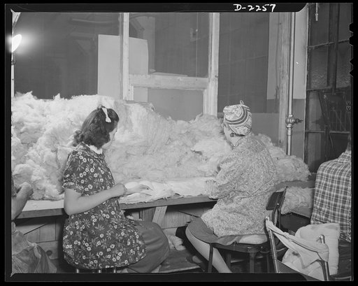 Bantam, Connecticut. The kapok room in the Warren McArthur upholstery shop is screened off to prevent the feathery filling from flying freely about the plant. Expert at stuffing kapok into cushions are Barbara Skilton and Frances Humphrey. Barbara, at left, lives in Morris, the next town to Bantam, 