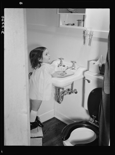 Bantam, Connecticut. Defense homes. Three-year-old Ann Heath, daughter of Fred Heath who operates a turret lathe in the Warren McArthur casting room. She has her own little footstool so that she can wash her own hands in the sink of the bathroom in the four-room defense housing unit where the Heaths