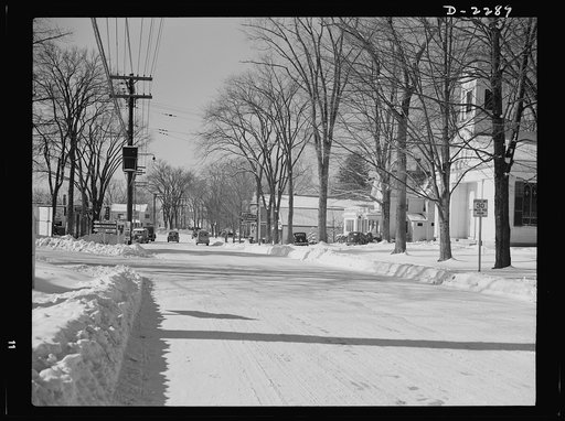 Bantam, Connecticut. The business section of Bantam with the camera facing south along Lafayette Boulevard (Route 25). A few rods to the left is the Warren McArthur plant, while the block of stores visible at the left includes Mitchell's Tavern, the First National Store, a garage and two service sta