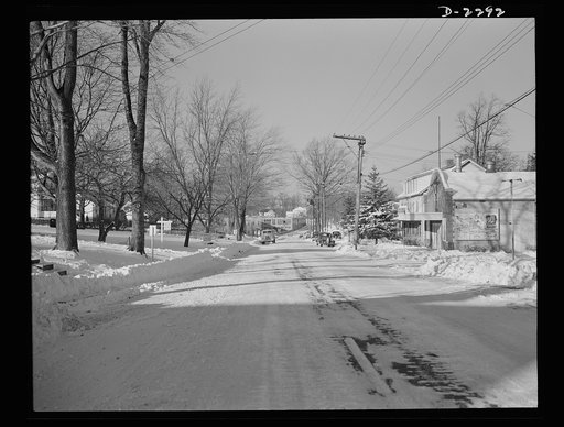 Bantam, Connecticut. Bantam Lane, looking toward the Warren McArthur plant and the center of town. To the left, now shown, are the new defense housing development and the Dante Electric Shop. In the right foreground is the Bantam theater. Blocked by the house next to the theater is the grocery store