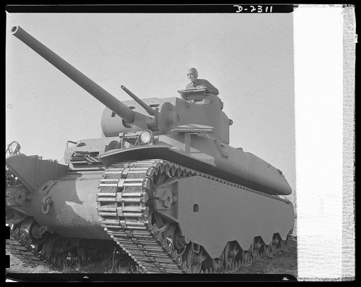 Delivery of the first heavy tanks. This is the new fifty-seven-ton tank, known as the M-1 in the initial demonstration. Notice that the gun turrets are on the top, making it possible for the tank to take advantage of irregular land, sheltering the lower part and shooting from revolving turrets on to