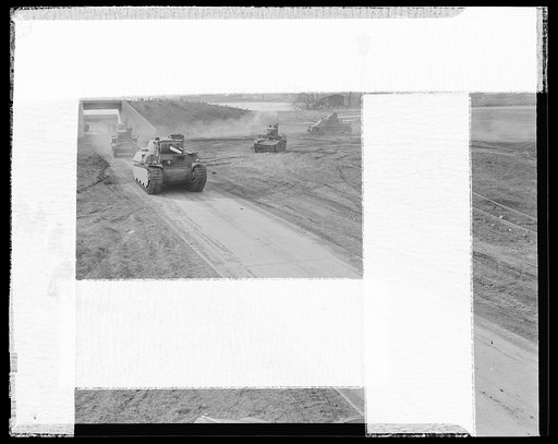 Delivery of the first heavy tanks. The new fifty-seven-ton tank, known as the M-1 leading a parade of tanks in its initial tryout demonstration. Background is the M-3 medium thirty-eight-ton tank. The other two are the M-3 light thirteen-and-a-half-ton tanks