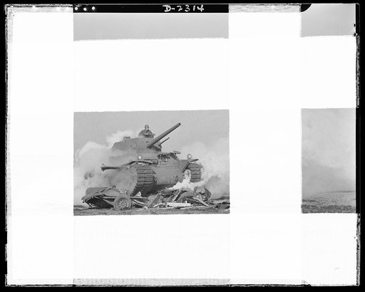 Delivery of the first heavy tanks. This is what happens when a truck gets in the path of Uncle Sam's new fifty-seven-ton giant tank. Running over this piece is as much trouble for the tank as running over a curb in an average automobile. The revolving turret on top of the tank contains a three-inch 