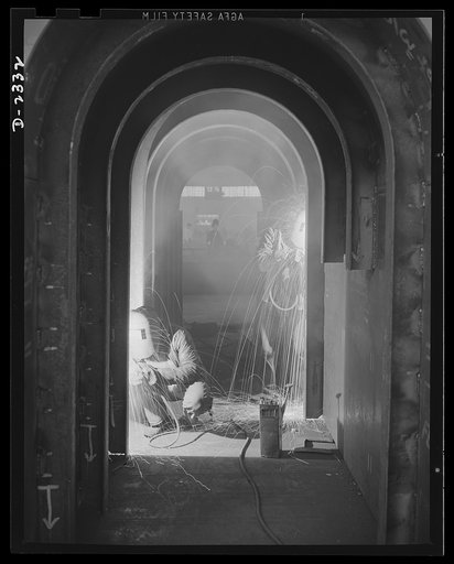 Shipbuilding. "Liberty" ships. Welding is one of the most important advances in shipbuilding during the present century with the torch resulting in immense savings in time, material and weight in the building of ships. This welder is joining side plates to angle frames forming section of the propell