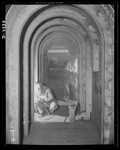 Shipbuilding. "Liberty" ships. Welding is one of the most important advances in shipbuilding during the present century with the torch resulting in immense savings in time, material and weight in the building of ships. This welder is joining side plates to angle frames forming section of the propell