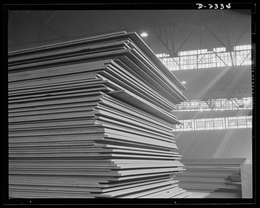 Shipbuilding. "Liberty" ships. These stacks of steel plate are in readiness for an uninterrupted flow toward the production line of a large Eastern plant fabricating sections for ships built at a nearby yard. This plant was formerly used for freight car construction. All parts are prefabricated in t