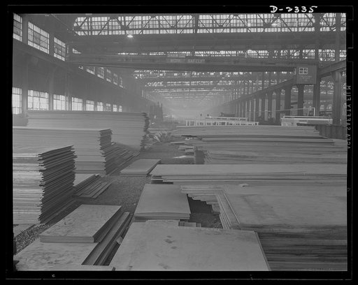 Shipbuilding. "Liberty" ships. Steel plates of wasteless dimensions stacked ready for laying out, one of the first operations on the production line of multiply cargo ship construction. All parts are prefabricated in this huge Eastern plant which formerly turned out freight cars. The completed secti
