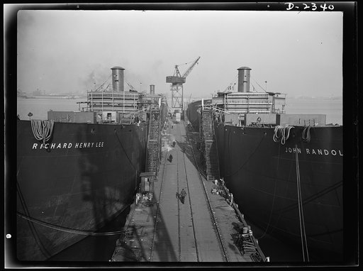 Shipbuilding. "Liberty" ships. Here are two members of the Liberty Fleet lying at anchor in the basin of a large Eastern shipyard. Bethlehem-Fairfield Shipyards Inc., Baltimore, Maryland
