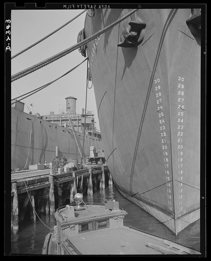 Shipbuilding. "Liberty" ships. Here are two members of the Liberty Fleet lying at anchor in the basin of a large Eastern shipyard, awaiting final fitting and rigging. Bethlehem-Fairfield Shipyards Inc., Baltimore, Maryland