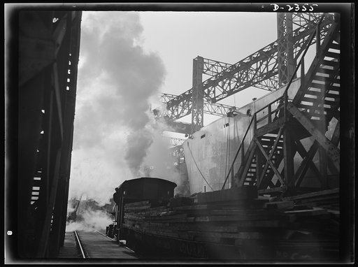 Shipbuilding. "Liberty" ships. Between the ways of this large Eastern shipyard run tracks for flat cars carrying materials or sections to be hoisted onto the decks of ships under construction