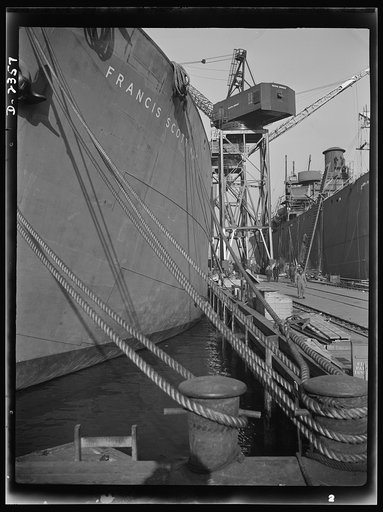 Shipbuilding. "Liberty" ships. Here are two members of the Liberty Fleet lying at anchor in the basin of a large Eastern shipyard, awaiting final fitting and rigging