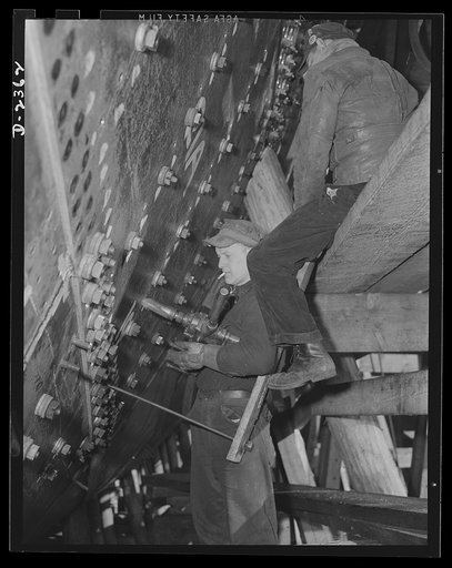 Shipbuilding. "Liberty" ships. Shell plates of a ship at the bow, where the inner plates are first bolted to the outer plates for added strength. The rivets are countersunk to be flush on the outer side. Production scene in a large Eastern shipyard. Bethlehem-Fairfield Shipyards Inc., Baltimore, Mar