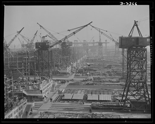 Shipbuilding. "Liberty" ships. This maze of rolling cranes, at a large Eastern shipyard is a typical scene in many large shipyards at work on ships for Uncle Sam's Navy and merchant fleet. Stocks of material are piled up for the cranes to take to vessels under construction so there is no delay in pr