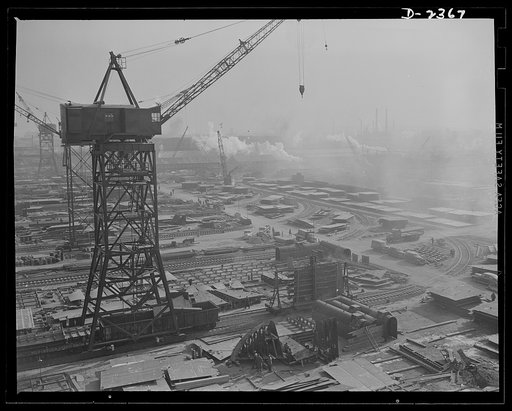 Shipbuilding. "Liberty" ships. This maze of rolling cranes, at a large Eastern shipyard is a typical scene in many large shipyards at work on ships for Uncle Sam's Navy and merchant fleet. Stocks of material are piled up for the cranes to take to vessels under construction so there is no delay in pr