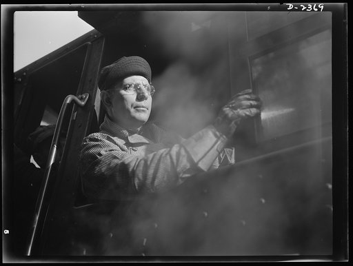 Shipbuilding. "Liberty" ships. Most large shipyards have their own rail systems, with several locomotives and flat cars used for hauling heavy ship parts about the yards. This man operates such a locomotive transporting completed sections from a former freight car plant six miles to the ways where t