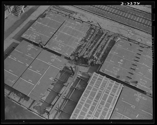 Shipbuilding. "Liberty" ships. These are prefabricated bulkhead sections for ships of the Liberty Fleet being welded together before they are hoisted into position in a new ship in front of a large Eastern yard. Bethlehem-Fairfield Shipyards Inc., Baltimore, Maryland