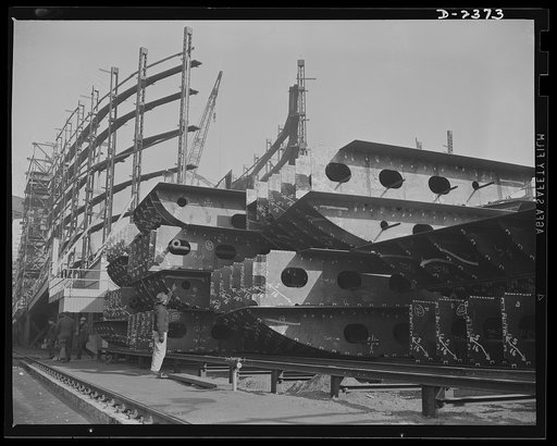 Shipbuilding. "Liberty" ships. This is the midship section of a new member of the Liberty Fleet, nearing completion at a large Eastern shipyard. In the background is a maze of scaffolding and cranes typical of the scene in many large American shipyards as builders work to make Uncle Sam master of th