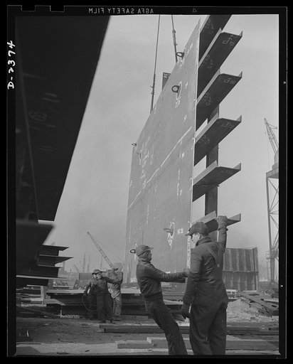 Shipbuilding. "Liberty" ships. All assembled and ready to go in place. Prefabrication of sections such as this in a nearby plant formerly making freight cars saves weeks in the building of ships for Uncle Sam's new merchant fleet. This piece is being hoisted into place, and soon the welder will begi
